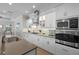 Bright, modern kitchen with stainless appliances, white cabinetry, and granite countertops at 15508 Leven Links Pl, Lakewood Ranch, FL 34202