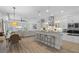 Modern kitchen with stainless steel appliances, breakfast bar, and an open layout at 15508 Leven Links Pl, Lakewood Ranch, FL 34202