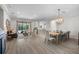 Spacious open-concept living and dining area with hardwood floors and modern lighting fixtures at 15508 Leven Links Pl, Lakewood Ranch, FL 34202