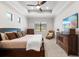 Comfortable main bedroom with tray ceiling, TV and neutral décor at 15508 Leven Links Pl, Lakewood Ranch, FL 34202