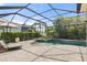 Beautiful screened-in pool and spa with brick-paved patio and lush landscaping at 15508 Leven Links Pl, Lakewood Ranch, FL 34202