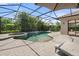 Stunning screened pool and spa with outdoor seating and lush, tropical landscaping at 15508 Leven Links Pl, Lakewood Ranch, FL 34202