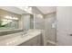 Bright bathroom with double sinks, quartz countertops, and a walk-in shower at 18137 Franklin Park Ct, Venice, FL 34293