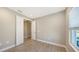 Light-filled bedroom with tile flooring, an open doorway to another room, and neutral decor at 18137 Franklin Park Ct, Venice, FL 34293