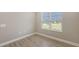 Bright bedroom with tiled floors, a window offering outdoor views, and fresh, neutral paint at 18137 Franklin Park Ct, Venice, FL 34293