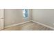 This bright bedroom features wood-look tile floors and a window with natural light at 18137 Franklin Park Ct, Venice, FL 34293