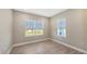 Well-lit bedroom with tile flooring, two windows for ample natural light, and neutral walls at 18137 Franklin Park Ct, Venice, FL 34293