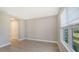 Bedroom with a window bringing in natural light, tile floors, and closet at 18137 Franklin Park Ct, Venice, FL 34293