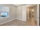 Bedroom featuring tile floors, an open doorway, and a window providing a view of the outdoors at 18137 Franklin Park Ct, Venice, FL 34293