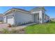 Exterior of home with a paved walkway, green lawn, and tasteful plantings to enhance curb appeal at 18137 Franklin Park Ct, Venice, FL 34293