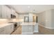 The spacious kitchen features stainless appliances, white cabinetry, and quartz countertops at 18137 Franklin Park Ct, Venice, FL 34293