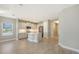 Bright kitchen features an island with stainless steel appliances and sink, with view of open area at 18137 Franklin Park Ct, Venice, FL 34293