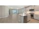 Modern kitchen with stainless appliances and a quartz island open to a spacious living area at 18137 Franklin Park Ct, Venice, FL 34293