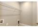 A convenient laundry room features a wire shelf for storage and utility hookups at 18137 Franklin Park Ct, Venice, FL 34293