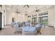 Clubhouse lounge area with comfortable seating, ceiling fans, and natural light at 18137 Franklin Park Ct, Venice, FL 34293
