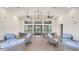 Community lounge area with stylish decor, comfortable seating, and views of the outdoor scenery at 18137 Franklin Park Ct, Venice, FL 34293