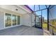 Pavered patio with large sliding glass doors to the interior and access to the screened-in lanai at 18137 Franklin Park Ct, Venice, FL 34293