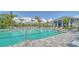 Community pool with umbrellas, chairs, and a clubhouse creating a resort-like experience at 18137 Franklin Park Ct, Venice, FL 34293