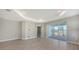Spacious room with tray ceiling, with sliding doors leading to the outside patio at 18137 Franklin Park Ct, Venice, FL 34293