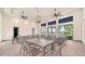 Bright lounge area featuring comfortable seating, ceiling fans, and multiple tables for gatherings at 18297 Vizcaya Ct, Venice, FL 34293