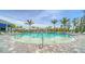 Stunning pool with shallow wading area is surrounded by lounge chairs and beautiful landscaping at 18297 Vizcaya Ct, Venice, FL 34293