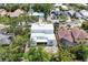 Aerial view showing the roof of new modern house highlighting proximity to lush foliage and neighborhood charm at 1879 Hibiscus St, Sarasota, FL 34239