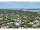 An aerial shot showcases a residential neighborhood near a bay with calm waters at 1879 Hibiscus St, Sarasota, FL 34239