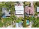 Overhead view showing roof of modern home next to neighbors with lush landscaping and swimming pools at 1879 Hibiscus St, Sarasota, FL 34239
