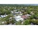 Overhead shot of a newly constructed white home nestled in a lush neighborhood, surrounded by mature trees at 1879 Hibiscus St, Sarasota, FL 34239