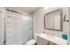Bathroom featuring shower with subway tile, sliding glass door, modern fixtures, and grey vanity at 22201 Olean Blvd, Port Charlotte, FL 33952