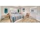 Bedroom with a bed, blue macrame, two windows, and light wood-look flooring at 22201 Olean Blvd, Port Charlotte, FL 33952