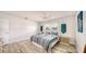 Bedroom with a bed, two windows, light floors, and a modern aesthetic at 22201 Olean Blvd, Port Charlotte, FL 33952