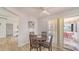 Dining area with a round wooden table, four chairs, and sliding glass doors leading to a sunroom at 22201 Olean Blvd, Port Charlotte, FL 33952