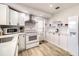 Clean kitchen with white cabinets, stainless appliances, and gray floors at 22201 Olean Blvd, Port Charlotte, FL 33952