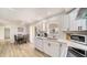 Bright kitchen with white cabinets, stainless appliances and an adjacent dining area with natural light at 22201 Olean Blvd, Port Charlotte, FL 33952
