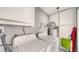 Functional laundry room features a washer, dryer, water heater, and ample cabinet storage space at 22201 Olean Blvd, Port Charlotte, FL 33952