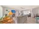 Bright living room with a ceiling fan, sliding glass doors to the lanai, and wood-look flooring at 22201 Olean Blvd, Port Charlotte, FL 33952
