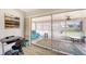 Sunroom with a daybed, desk, tile floors, and large sliding glass doors at 22201 Olean Blvd, Port Charlotte, FL 33952