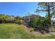 View of the screened lanai and landscaped yard at 2311 Falcon Trace Ln, Nokomis, FL 34275
