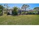 View of the screened lanai from the manicured backyard at 2311 Falcon Trace Ln, Nokomis, FL 34275