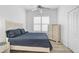 Cozy bedroom boasts plenty of natural light from the window with plantation shutters at 2311 Falcon Trace Ln, Nokomis, FL 34275