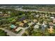 Aerial view of a community with golf course and lakes, surrounded by beautiful homes with mature trees at 2311 Falcon Trace Ln, Nokomis, FL 34275