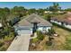 An aerial view of a single-story home with a gray tiled roof and well manicured yard at 2311 Falcon Trace Ln, Nokomis, FL 34275
