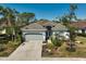 Well-maintained home with a tile roof, two-car garage, and mature landscaping at 2311 Falcon Trace Ln, Nokomis, FL 34275