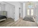 Bright foyer featuring wood-look flooring, clerestory window and decorative glass front doors at 2311 Falcon Trace Ln, Nokomis, FL 34275