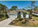 Charming single-story home featuring a tile roof, well-maintained landscaping, and an attached two-car garage at 2311 Falcon Trace Ln, Nokomis, FL 34275