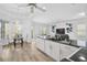Open kitchen layout with granite counters, white cabinets and seating area at 2311 Falcon Trace Ln, Nokomis, FL 34275