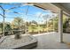 Covered lanai with a beautiful view of the landscaped backyard at 2311 Falcon Trace Ln, Nokomis, FL 34275