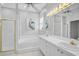 Large main bathroom features dual sinks, white tile, a soaking tub, and a walk-in shower at 2311 Falcon Trace Ln, Nokomis, FL 34275