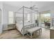 Light-filled main bedroom offers a sitting area and sliding glass doors to the lanai at 2311 Falcon Trace Ln, Nokomis, FL 34275